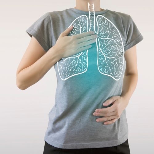 Image of a woman with her hand on her chest above an overlay image of a lung on her gray shirt