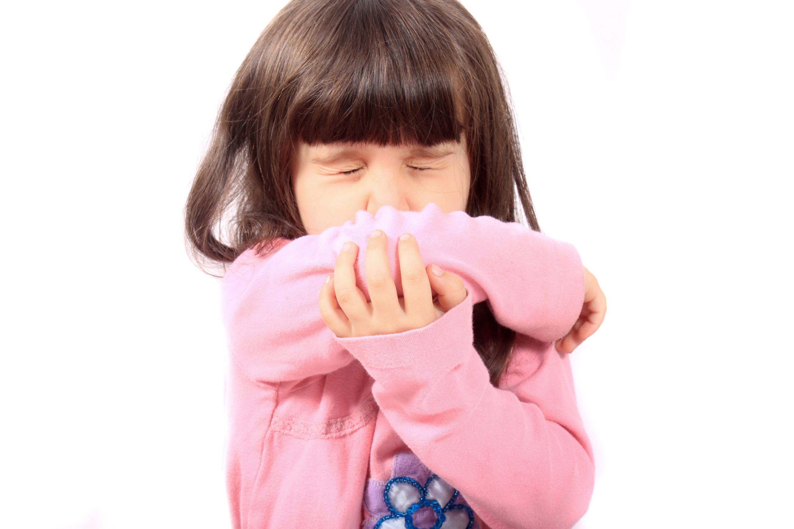 Image of a young girl sneezing into her inner arm