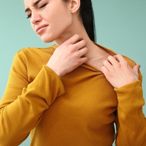 Image of a woman scratching her neck